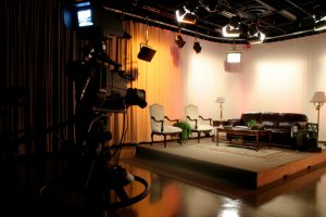 TV production studio with a stage being set up with props and proper lighting